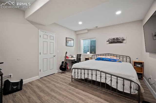 bedroom with hardwood / wood-style floors