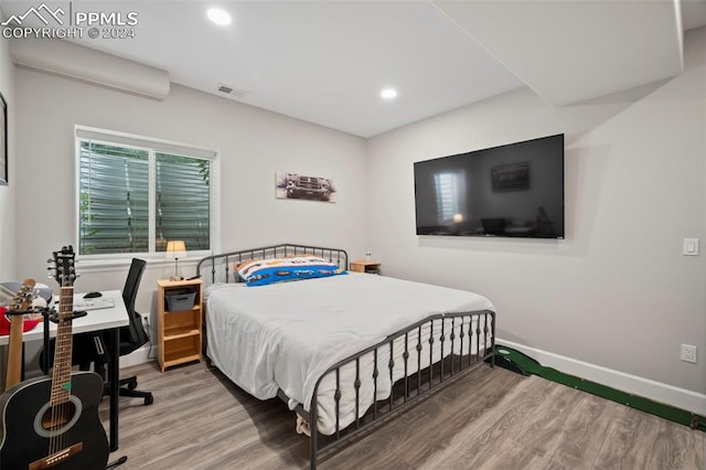 bedroom with hardwood / wood-style floors