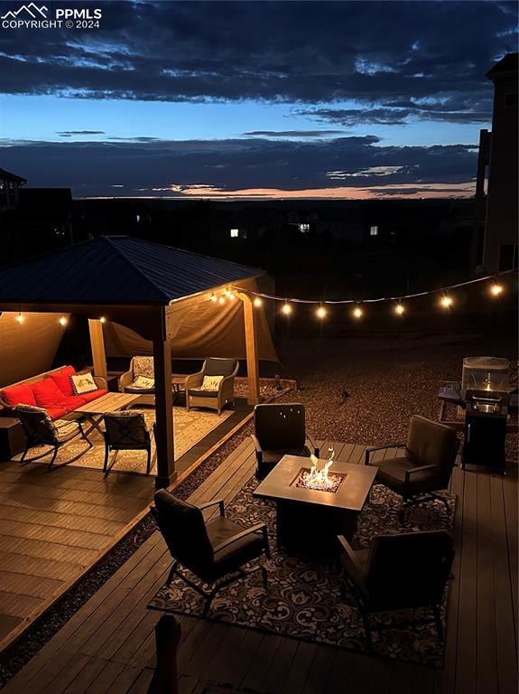 deck at dusk with an outdoor hangout area