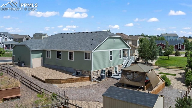 rear view of house with central AC unit