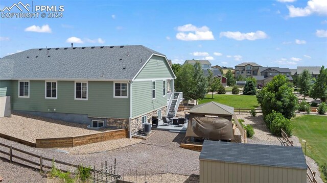 rear view of property featuring a patio area and a lawn