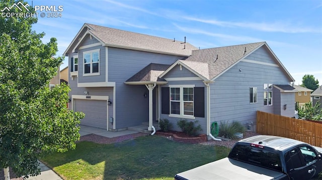 view of front of house featuring a garage and a front lawn