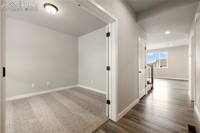 corridor featuring dark hardwood / wood-style floors