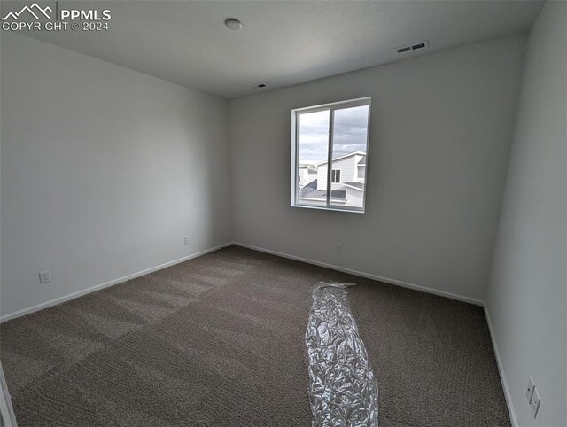 unfurnished room featuring carpet flooring