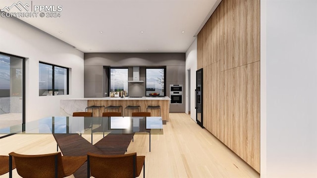 dining space with light hardwood / wood-style floors