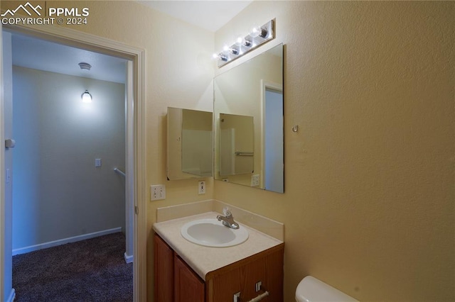 bathroom with vanity and toilet