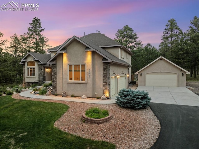 view of front of house with a yard and a garage