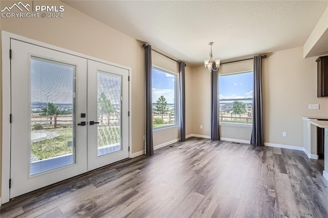 doorway to outside with hardwood / wood-style floors, a healthy amount of sunlight, and french doors