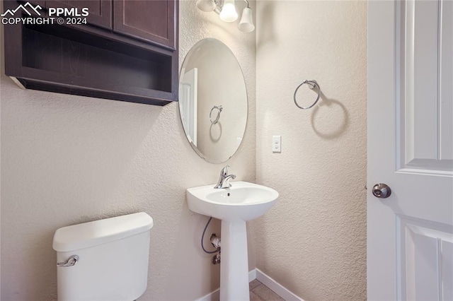 bathroom featuring toilet and sink