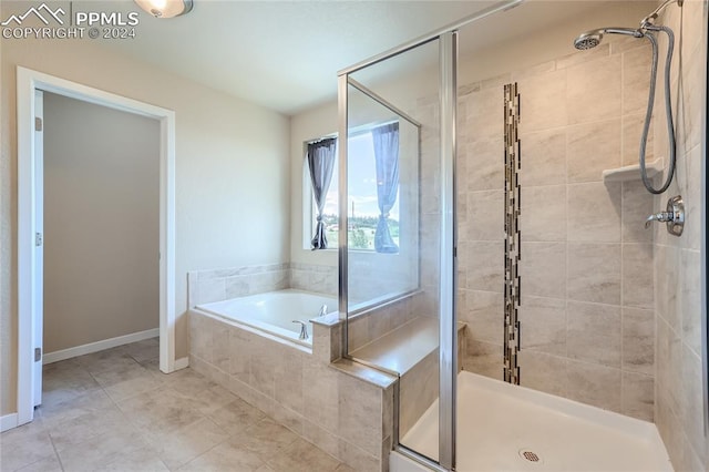 bathroom featuring shower with separate bathtub