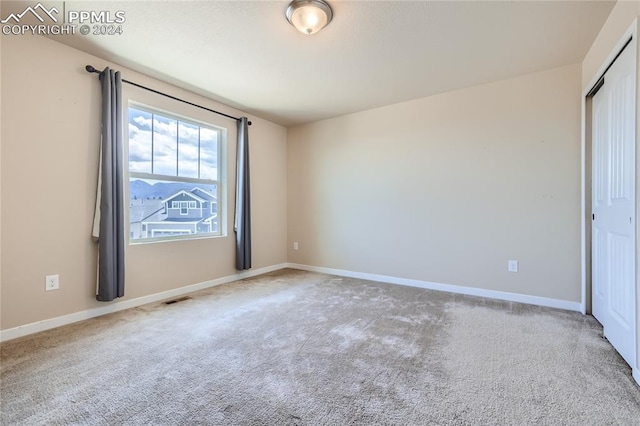 interior space featuring a closet and light colored carpet