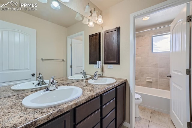 full bathroom with toilet, vanity, tiled shower / bath combo, and tile patterned flooring