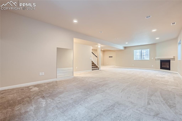 unfurnished living room featuring light carpet