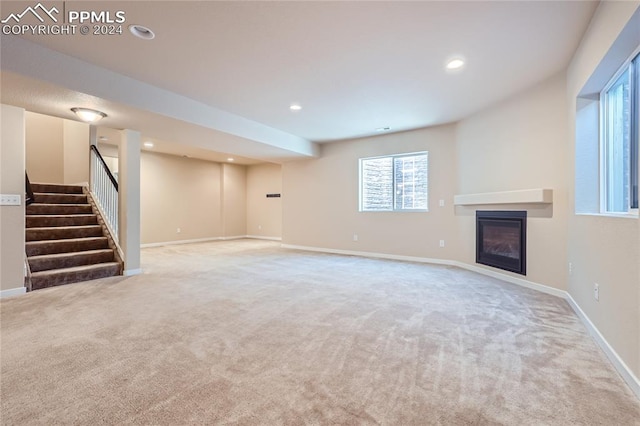 unfurnished living room with light colored carpet