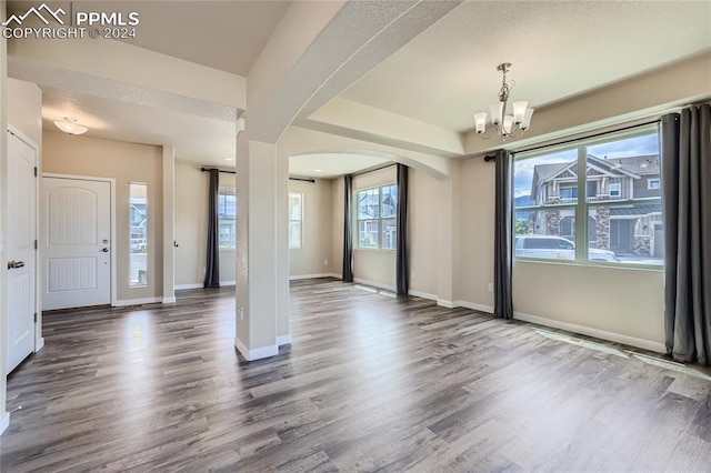 entryway with a wealth of natural light and hardwood / wood-style flooring