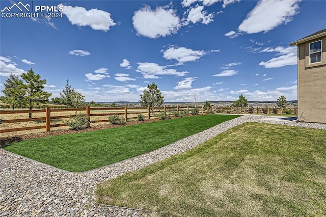 view of yard with a rural view