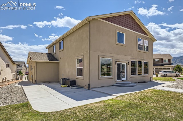 rear view of property featuring a yard and a patio