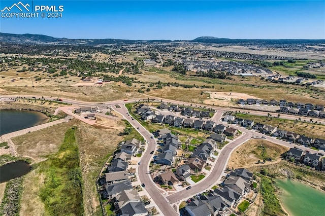 bird's eye view with a water and mountain view