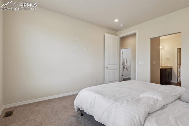 carpeted bedroom with ensuite bath