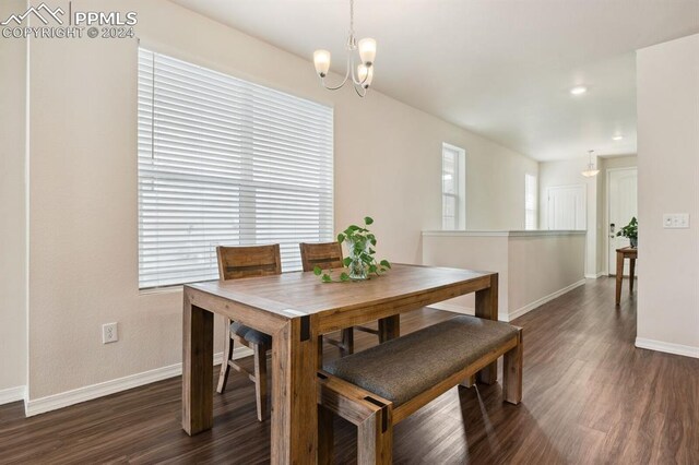 dining area with a chandelier and dark hardwood / wood-style floors