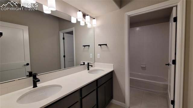 bathroom with tile patterned flooring, shower / bathing tub combination, and vanity