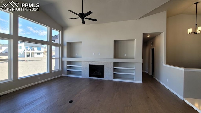 unfurnished living room featuring built in shelves, ceiling fan with notable chandelier, dark hardwood / wood-style floors, and lofted ceiling