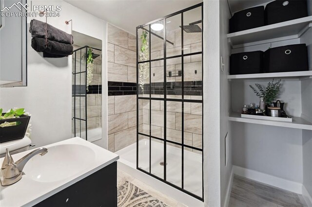 bathroom featuring vanity and an enclosed shower