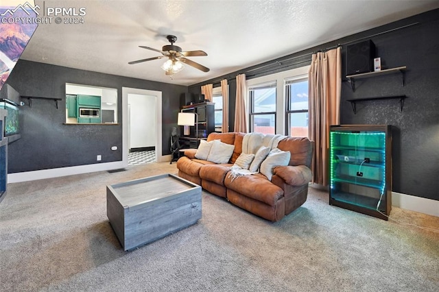 carpeted living room featuring ceiling fan