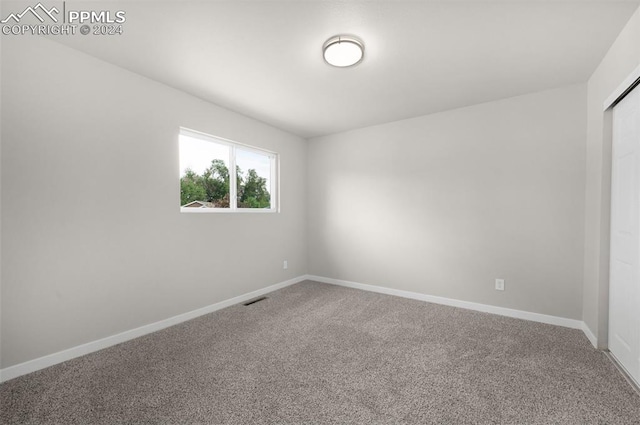 unfurnished room featuring carpet