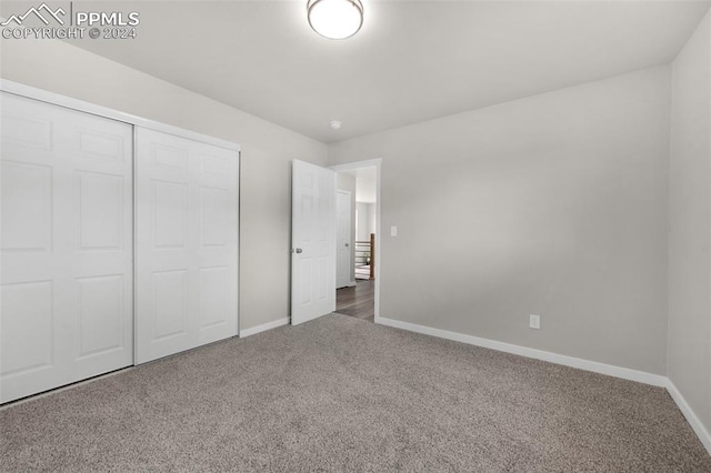 unfurnished bedroom featuring a closet and carpet