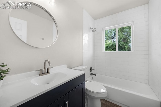 full bathroom with vanity, toilet, hardwood / wood-style flooring, and tiled shower / bath