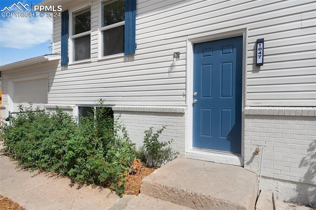 view of exterior entry with a garage