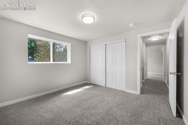 unfurnished bedroom featuring a closet and carpet floors