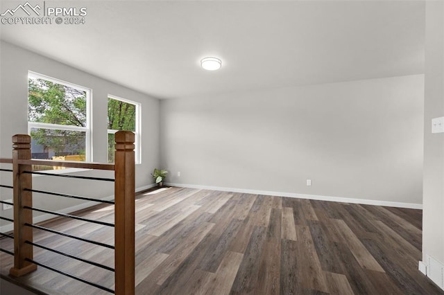 empty room with dark wood-type flooring