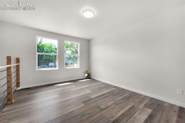 unfurnished room with wood-type flooring