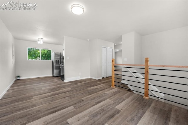 unfurnished living room with dark hardwood / wood-style floors