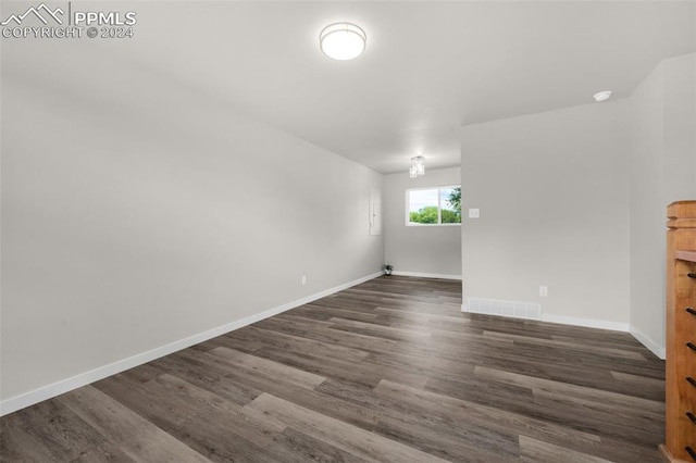 spare room featuring dark wood-type flooring