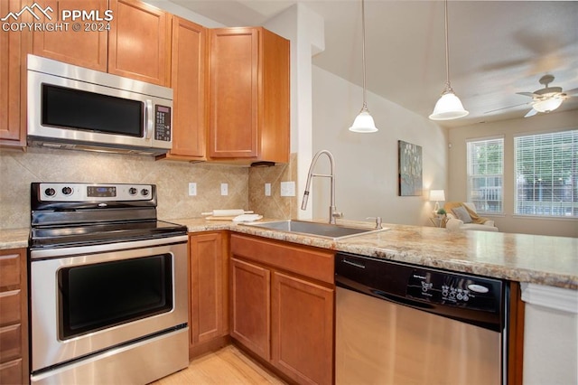 kitchen featuring ceiling fan, decorative light fixtures, backsplash, sink, and stainless steel appliances