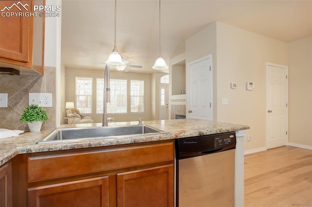 kitchen featuring ceiling fan, dishwasher, light hardwood / wood-style floors, sink, and hanging light fixtures