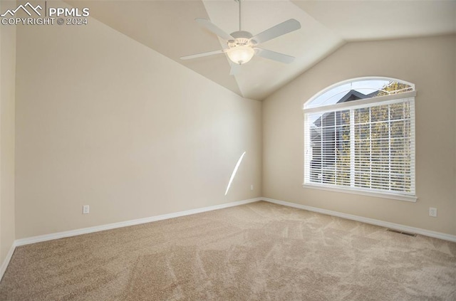 carpeted spare room featuring ceiling fan and lofted ceiling