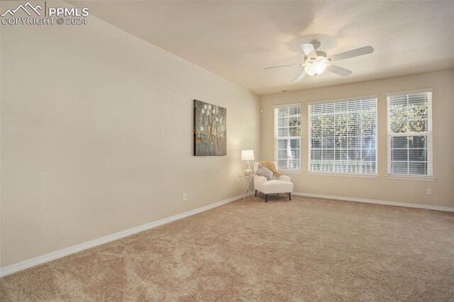 unfurnished room featuring ceiling fan and light colored carpet