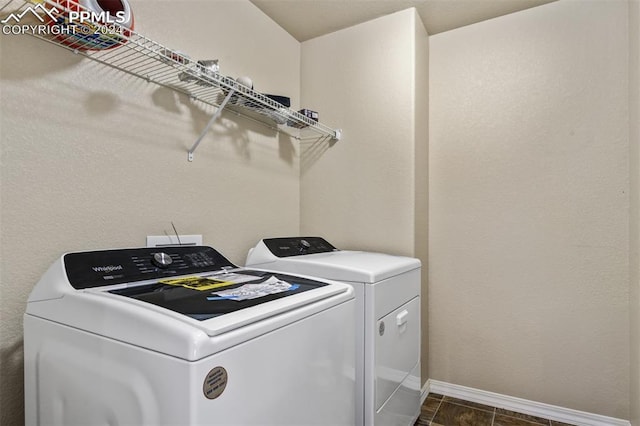 clothes washing area featuring separate washer and dryer