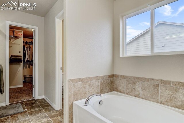 bathroom with a tub to relax in