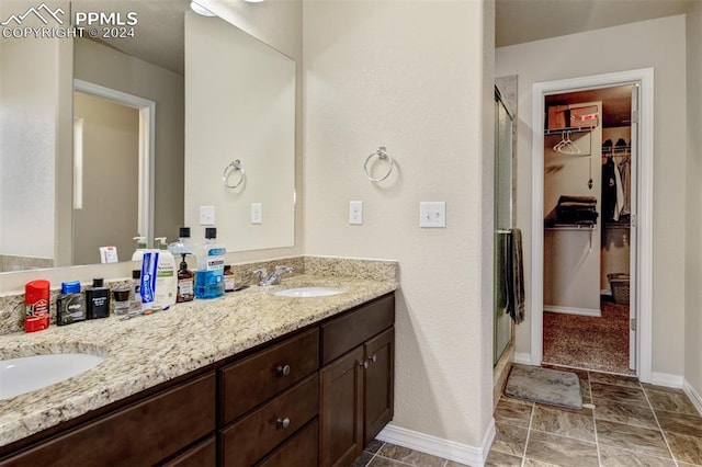 bathroom featuring vanity and a shower with door