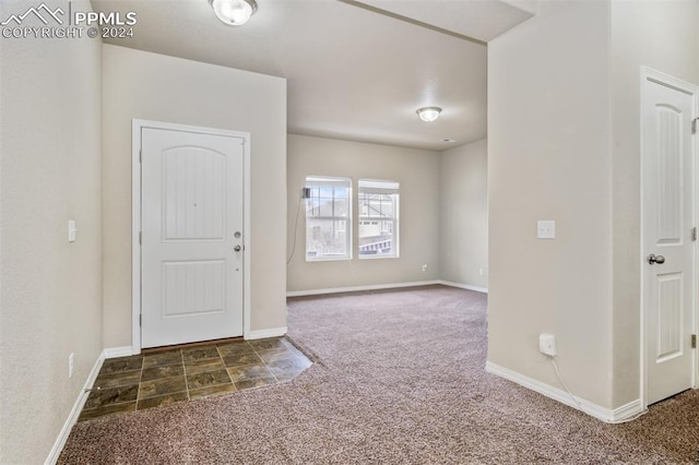 entryway with dark carpet