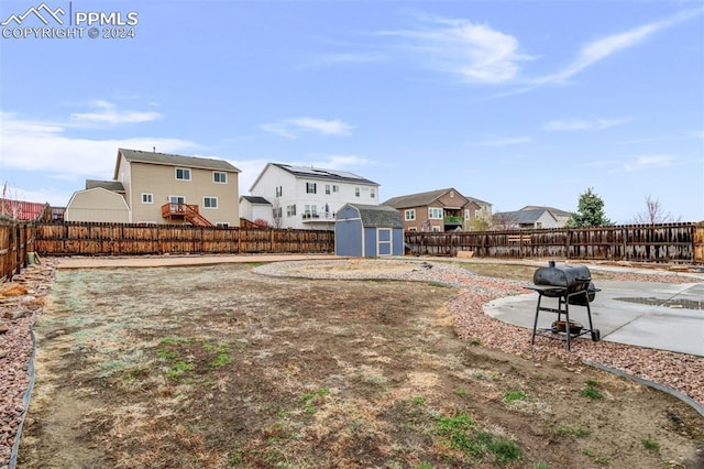 view of yard with a patio and a shed