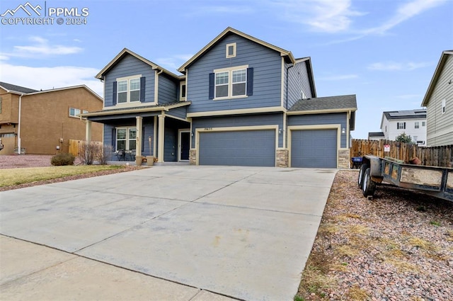 view of front of property featuring a porch and a garage