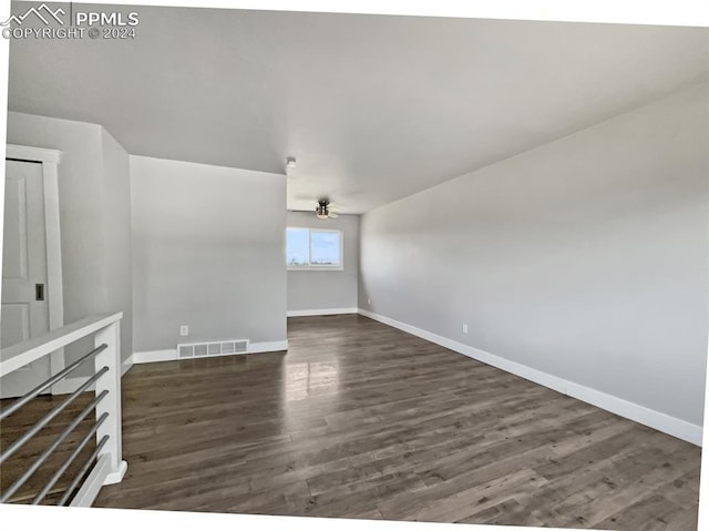 unfurnished living room with ceiling fan and dark hardwood / wood-style flooring