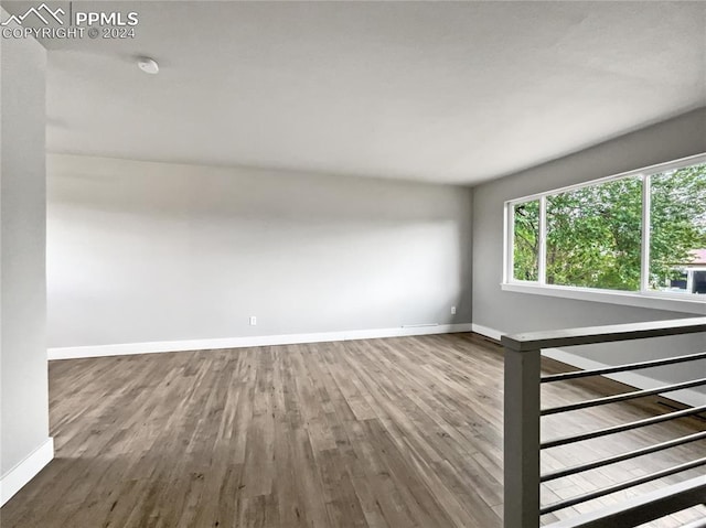 unfurnished room with wood-type flooring