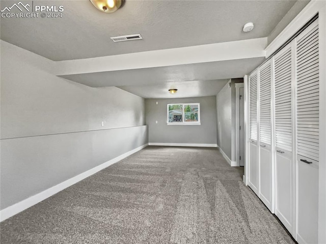 unfurnished bedroom featuring a closet and carpet floors